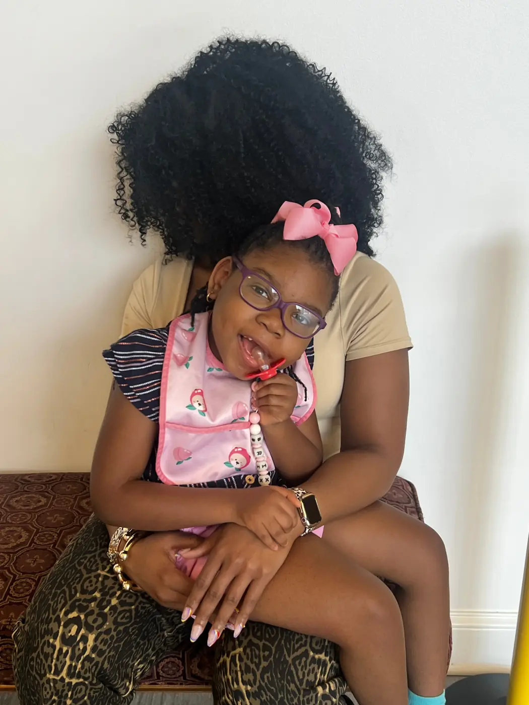 Phoenix, smiling in her mother's lap